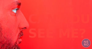 Red image with very low contrast text and a face of man trying to res the text